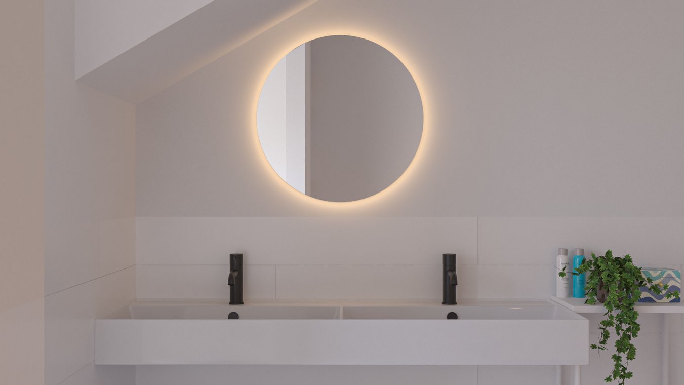 Bathroom with double sink, round mirror and stylish lighting.