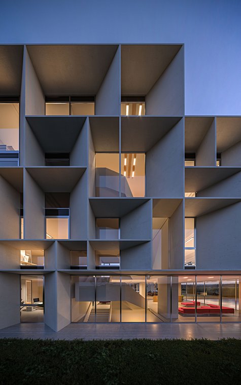 3D Visualization of the geometric façade of the Bentini Headquarters with deep structures and warmly lit offices.