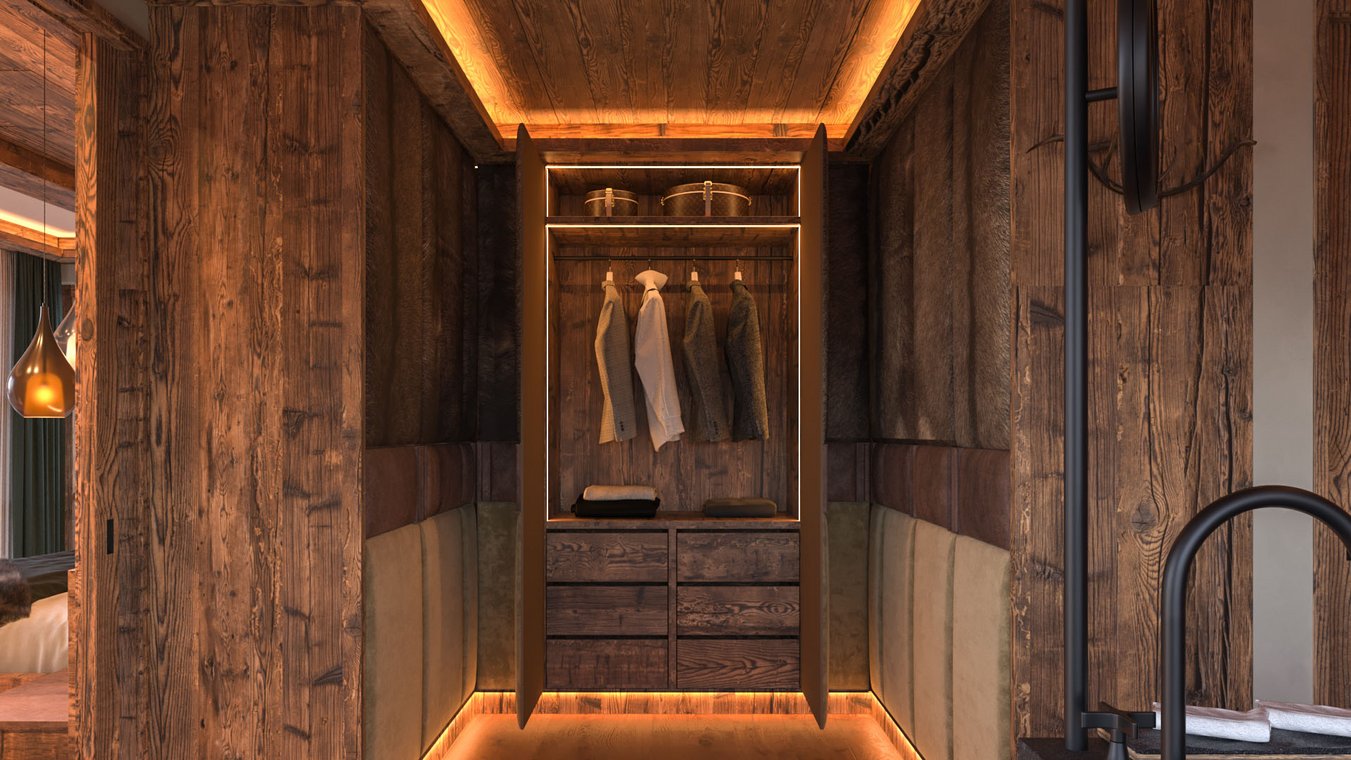 3D Visualization of a walk-in wardrobe in a Kitzbühel chalet, with wood paneling, modern lighting, and elegant storage solutions – designed by gmsvision.
