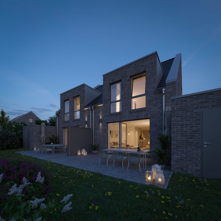 Evening view of the semi-detached house with terrace and garden, atmospheric lighting.