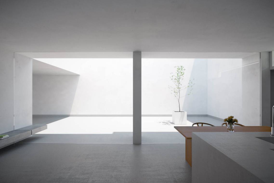 minimalistischer Wohnraum mit Blick in den Innenhof des White Cave House
