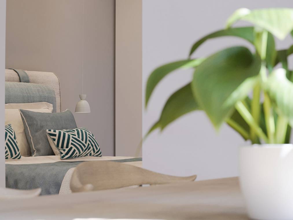 3d visualisierung mit Blick durch den Eingang ins Schlafzimmer der Ostsee-Ferienwohnung, im Vordergrund eine grüne Pflanze.